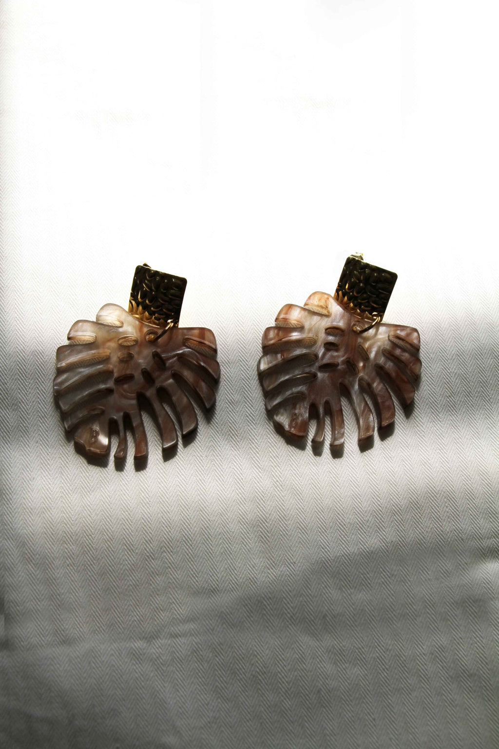 Detalle del efecto marmolado marrón de los Pendientes Monstera